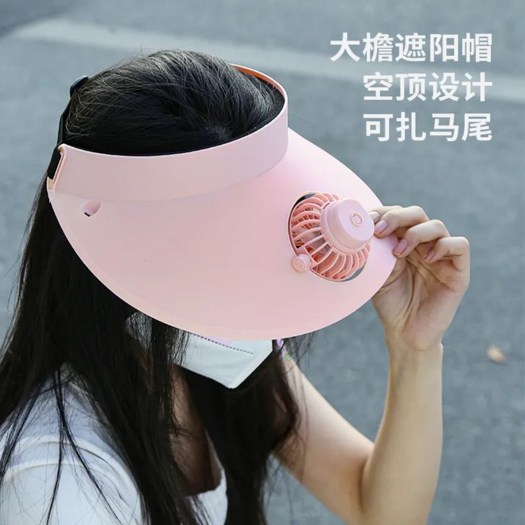 Model wearing cooling fan visor hat while hiking in sun