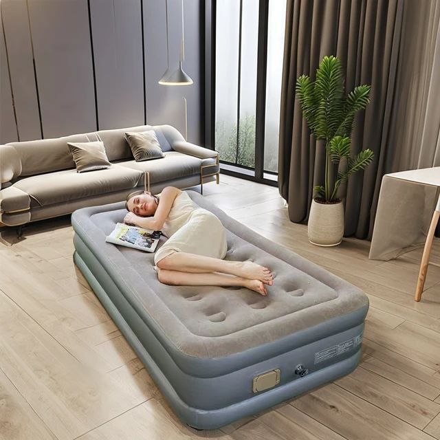 Single-size inflatable air mattress with integrated electric pump for camping or guest use